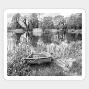 Boat on the bank of a rural lake in the Norfolk countryside, UK Sticker